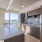 Luxury Three-Bedroom apartments in San Francisco, CA - Etta Apartments - Kitchen with Stainless Steel Appliances, a Large Island, and Modern Brown Cabinetry