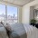 bed near window with city view